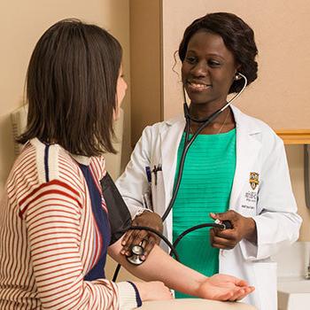 Healthcare worker taking patient's blood pressure