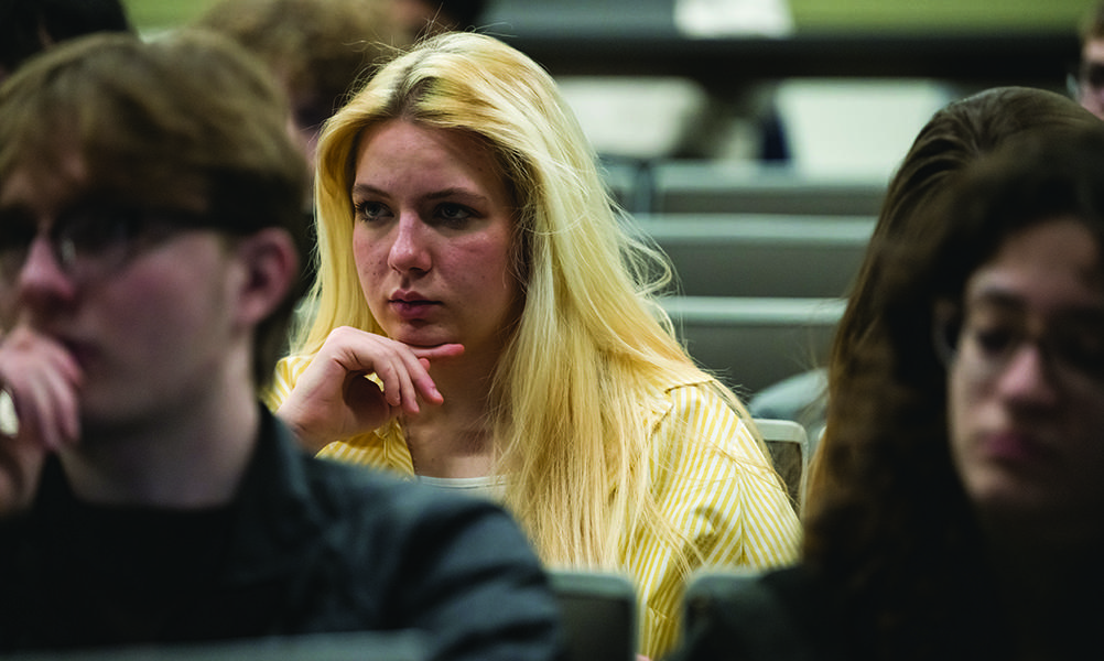 Close-up of face of Yushchenko as she sits in class in lecture hall.